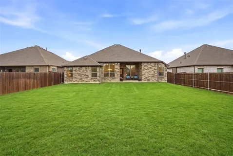 a view of a house with a yard and sitting area