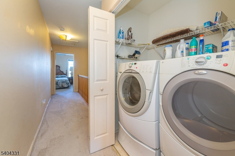 404 Manchester Drive Nutley, NJ 07110 - Photo 19 of 26 a view of a hallway with washer and dryer