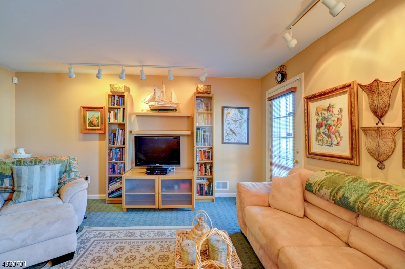 404 Manchester Drive Nutley, NJ 07110 - Photo 23 of 26 a living room with furniture and a flat screen tv