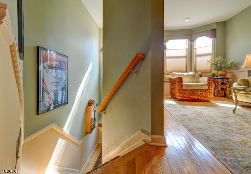 404 Manchester Drive Nutley, NJ 07110 - Photo 4 of 26 a view of an entryway with wooden floor and windows