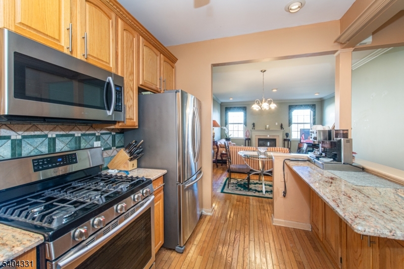404 Manchester Drive Nutley, NJ 07110 - Photo 8 of 26 a kitchen with stainless steel appliances granite countertop a stove refrigerator and a microwave oven