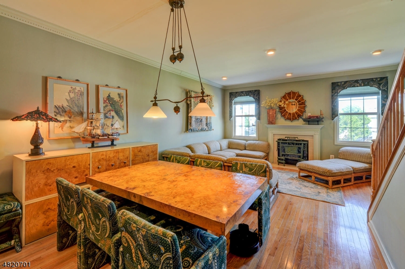 404 Manchester Drive Nutley, NJ 07110 - Photo 9 of 26 a dining room with furniture and a fireplace