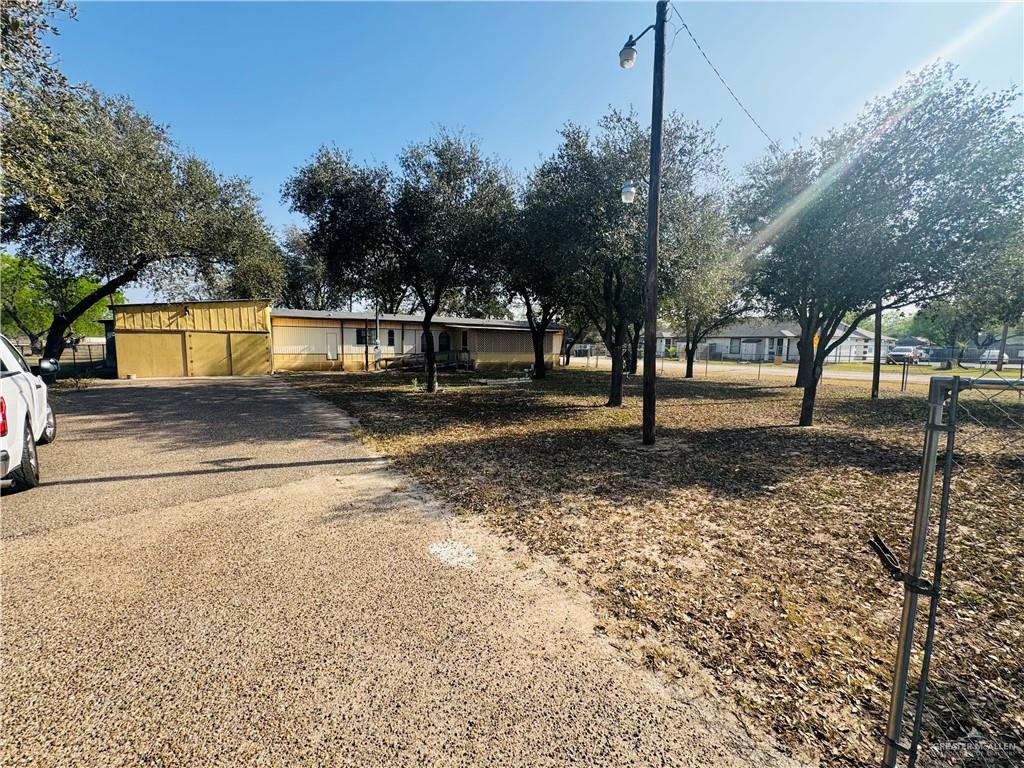 8007 Tex Mex Road Edinburg, TX 78542 - Photo 3 of 24 a view of a yard with a tree