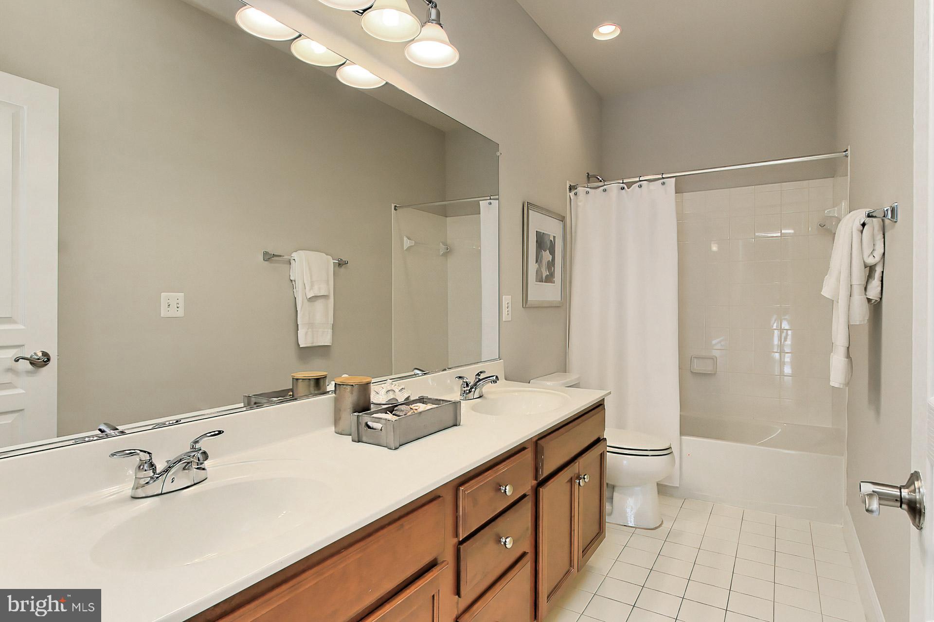 23106 Bronstein Lane Brambleton, VA 20148 - Photo 25 of 58 Shared Bath w/ Double Sinks and Ceramic Tile Flrg