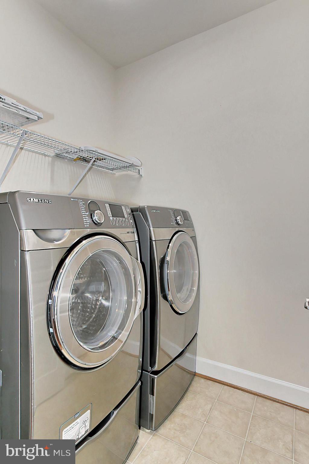 23106 Bronstein Lane Brambleton, VA 20148 - Photo 27 of 58 Upper Foyer Laundry Room w/ Front Load W/D