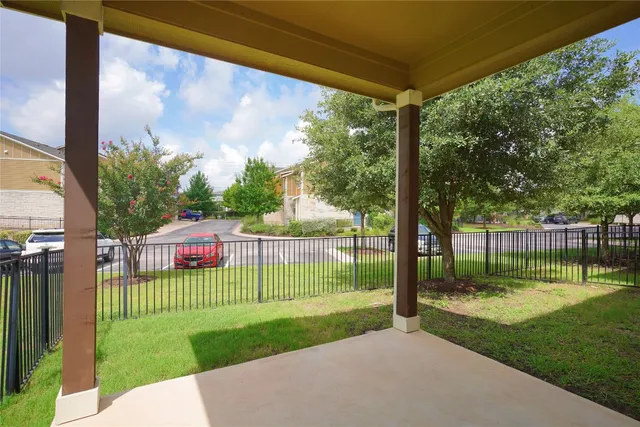 a view of a porch with a big yard and a fountain