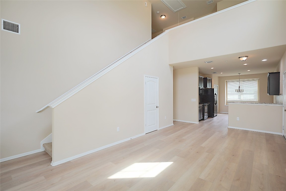 516 East Slaughter Lane, Unit 801 Austin, TX 78744 - Photo 3 of 16 a view of an empty room with wooden floor