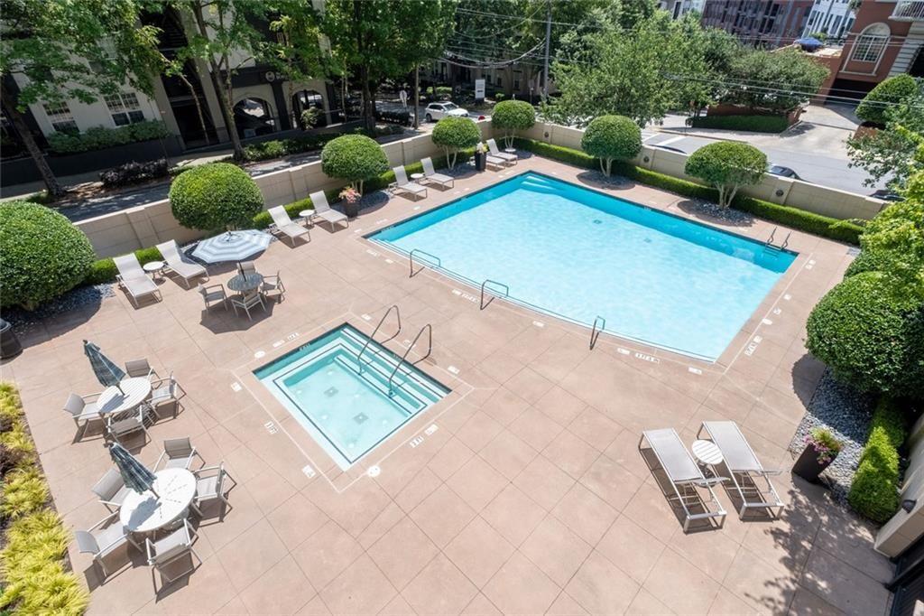 3475 Oak Valley Road Northeast, Unit 910 Atlanta, GA 30326 - Photo 24 of 27 an aerial view of a swimming pool with lawn chairs and plants