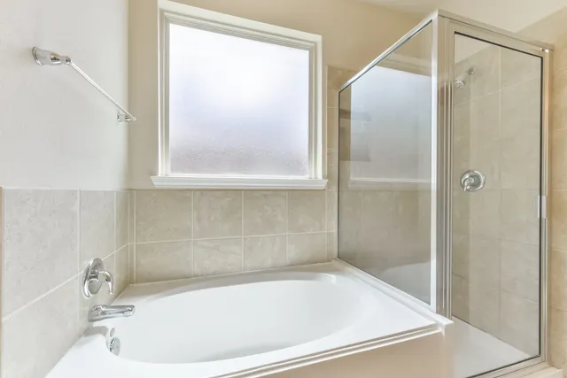 a bathroom with a tub and a sink