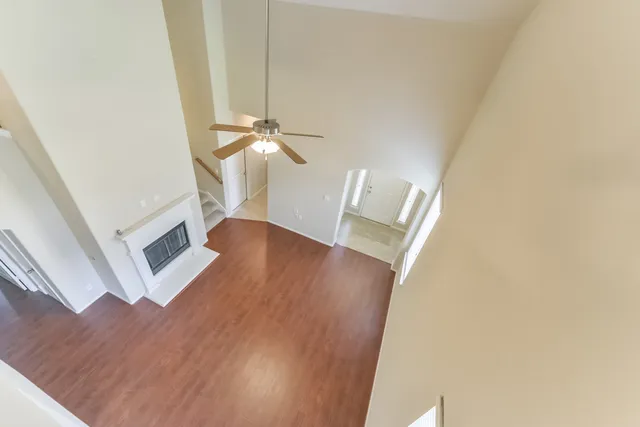 a view of a livingroom with wooden floor and staircase