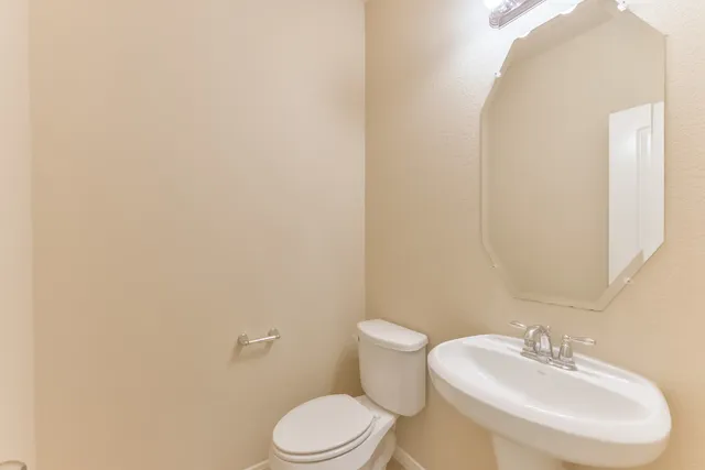 a white toilet sitting next to a white sink