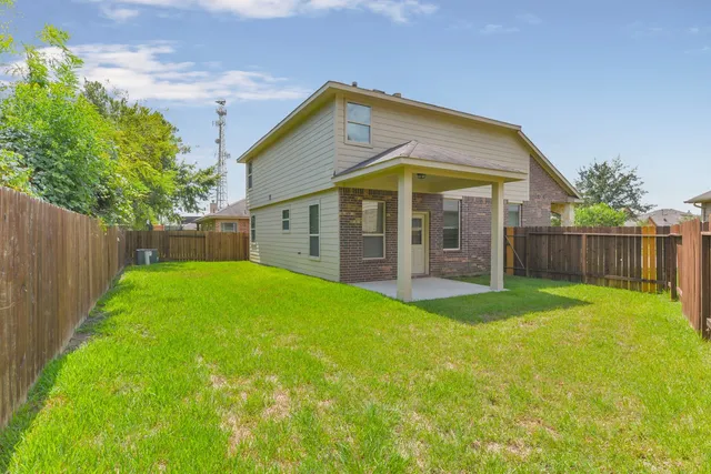 a view of a house with a yard and sitting area