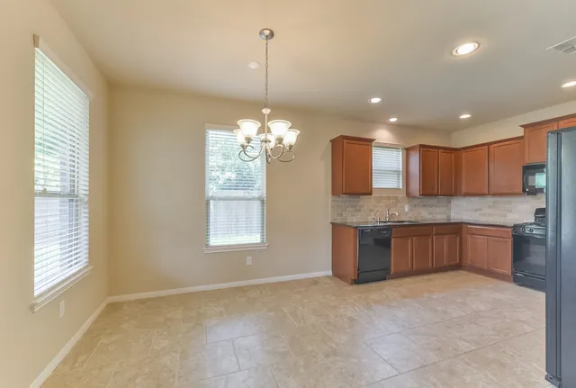a large kitchen with a chandelier