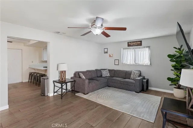 a living room with furniture and a wooden floor