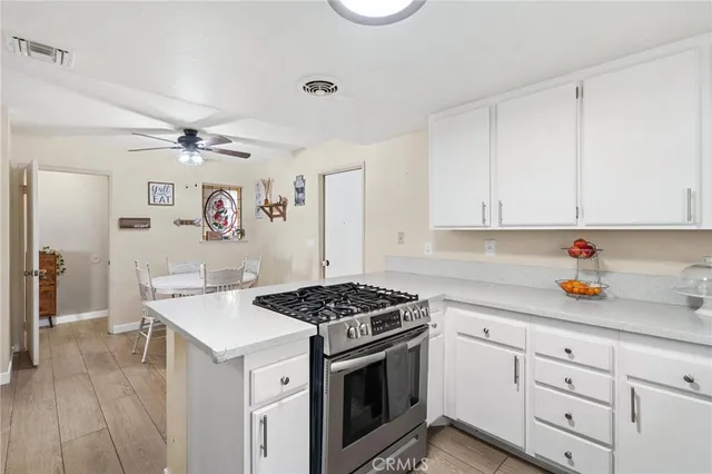 a kitchen with cabinets stainless steel appliances and a counter space