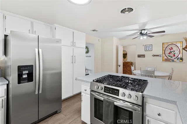 a kitchen with stainless steel appliances granite countertop a stove and a refrigerator