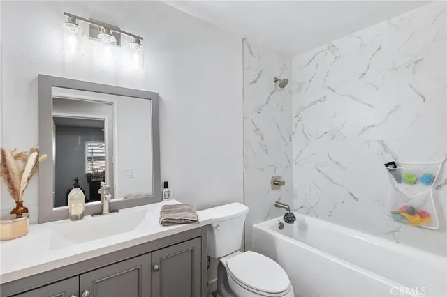 a bathroom with a sink a toilet and bathtub