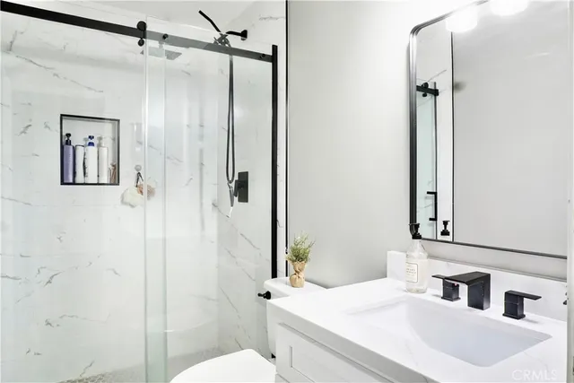 a bathroom with a sink toilet and shower