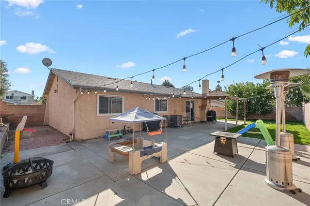 a view of a patio with table and chairs potted plants