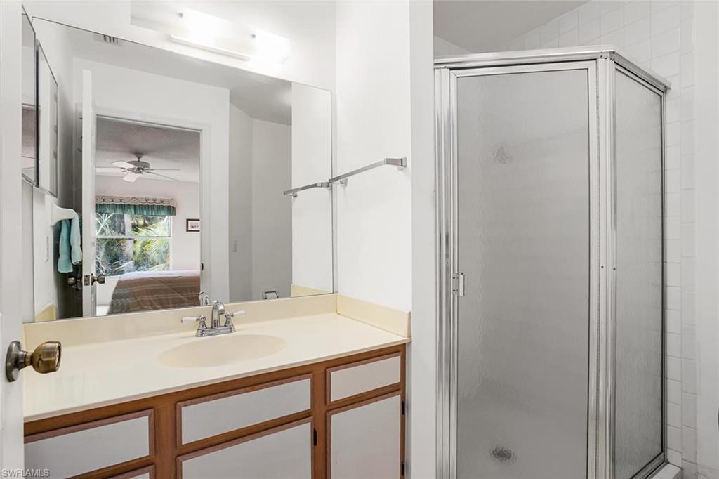 741 Landover Circle, Unit 203 Naples, FL 34104 - Photo 11 of 21 a view of bathroom with a sink and mirror