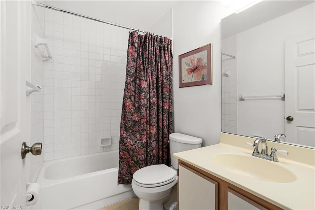 741 Landover Circle, Unit 203 Naples, FL 34104 - Photo 14 of 21 a bathroom with a sink toilet and shower