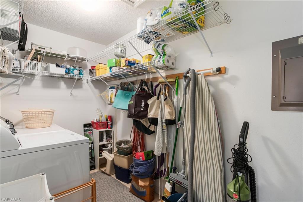 741 Landover Circle, Unit 203 Naples, FL 34104 - Photo 15 of 21 a view of storage and utility room with a sink and toys
