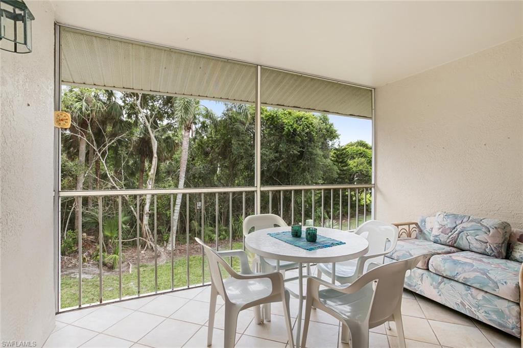 741 Landover Circle, Unit 203 Naples, FL 34104 - Photo 16 of 21 a view of a dining room with furniture window and outside view