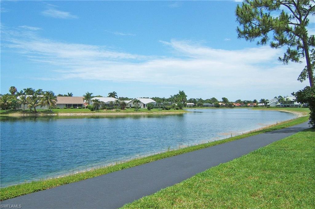 741 Landover Circle, Unit 203 Naples, FL 34104 - Photo 21 of 21 a view of a lake with houses in the back