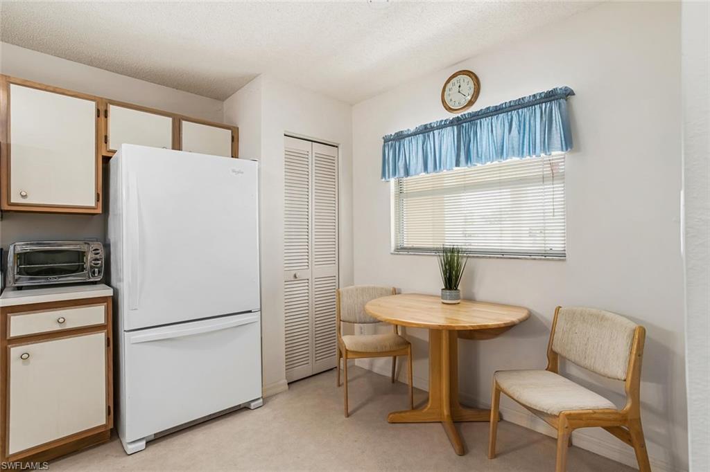 741 Landover Circle, Unit 203 Naples, FL 34104 - Photo 6 of 21 a white refrigerator freezer sitting in a kitchen