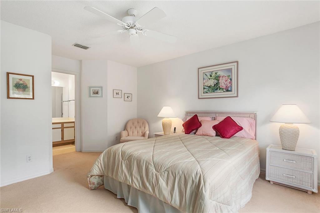 741 Landover Circle, Unit 203 Naples, FL 34104 - Photo 10 of 21 a bed room with a bed and a closet
