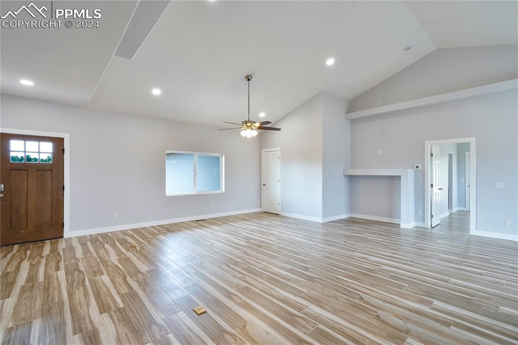 8081 Granger Road Rye, CO 81069 - Photo 13 of 42 an empty room with wooden floor ceiling fan and windows