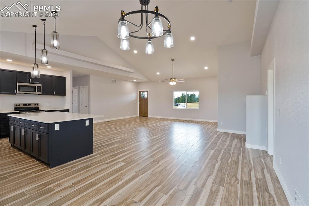 8081 Granger Road Rye, CO 81069 - Photo 14 of 42 a large kitchen with stainless steel appliances granite countertop a large island a oven a stove and a wooden floors