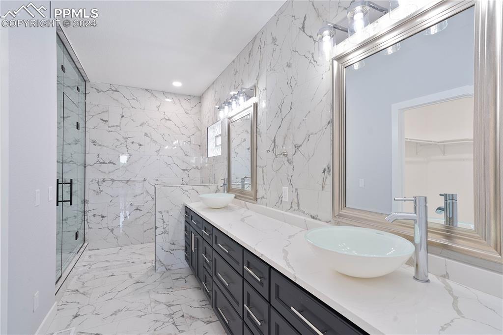 8081 Granger Road Rye, CO 81069 - Photo 17 of 42 a bathroom with a granite countertop sink a toilet a mirror and shower