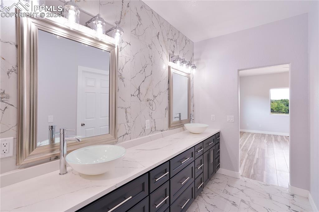 8081 Granger Road Rye, CO 81069 - Photo 22 of 42 a bathroom with a granite countertop double vanity sink and a mirror