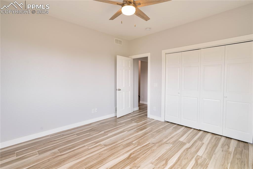 8081 Granger Road Rye, CO 81069 - Photo 25 of 42 an empty room with a ceiling fan and wooden floor
