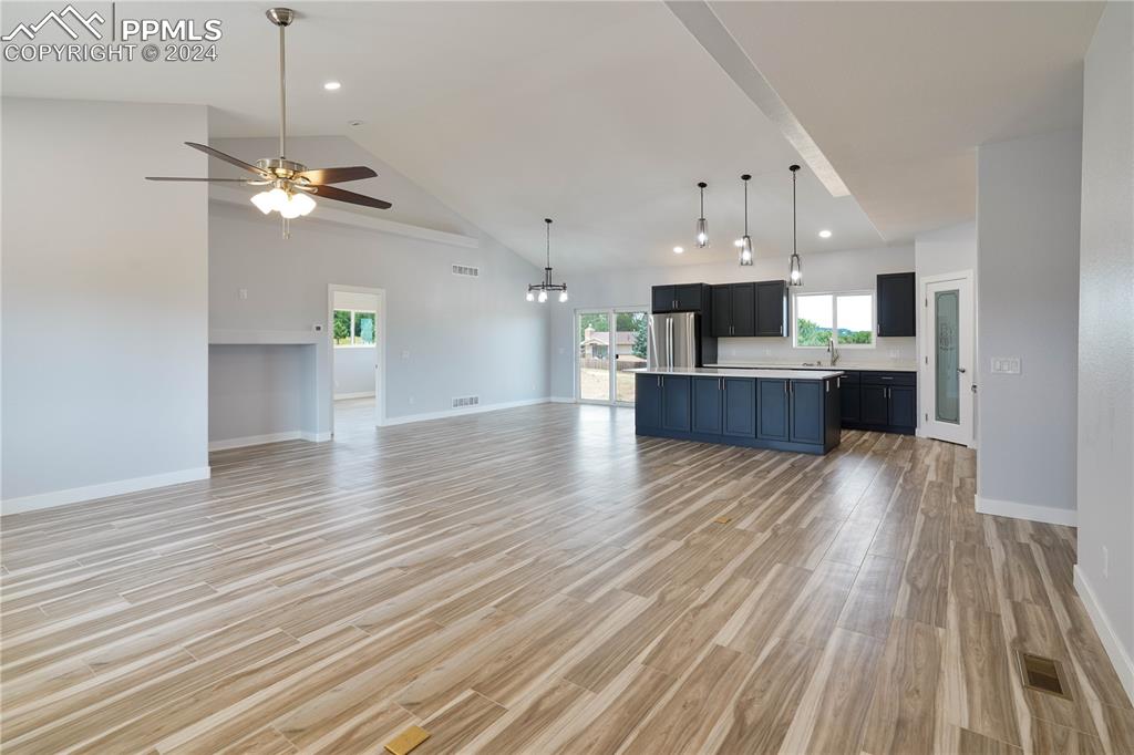 8081 Granger Road Rye, CO 81069 - Photo 6 of 42 a view of a kitchen with a dishwasher a kitchen island hardwood floor and a ceiling fan