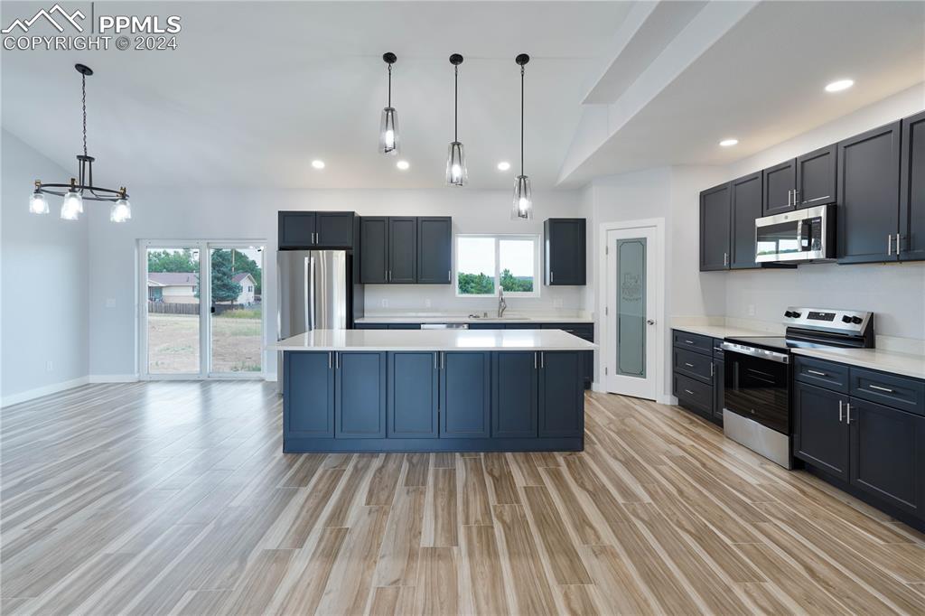 8081 Granger Road Rye, CO 81069 - Photo 8 of 42 a large kitchen with stainless steel appliances granite countertop a large center island a stove a refrigerator and a sink