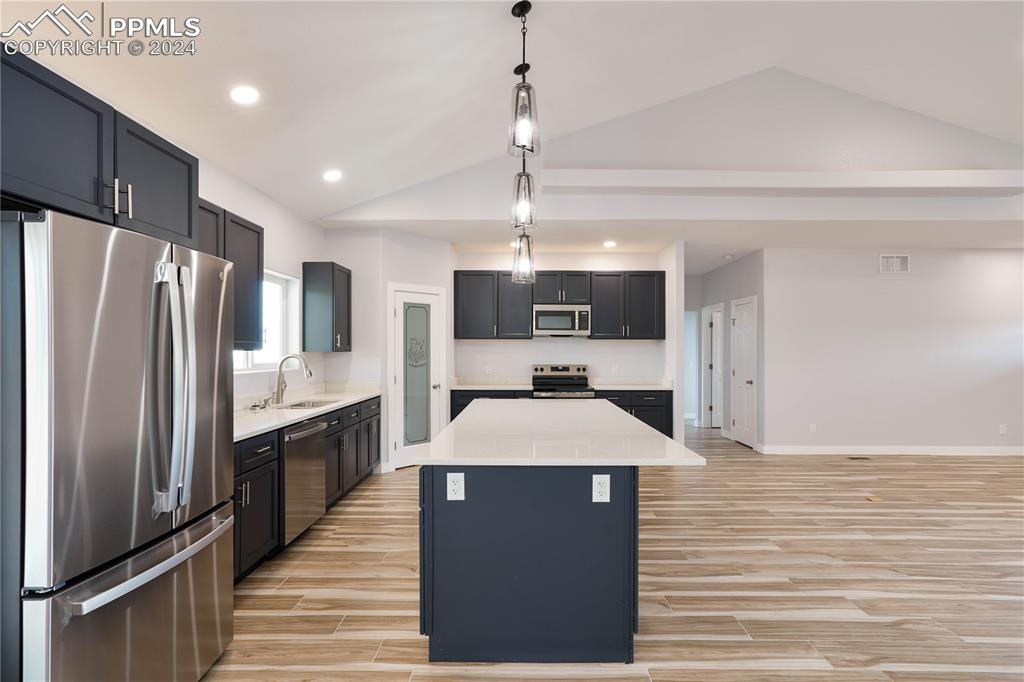 8081 Granger Road Rye, CO 81069 - Photo 10 of 42 a kitchen with stainless steel appliances kitchen island granite countertop a refrigerator a sink and dishwasher