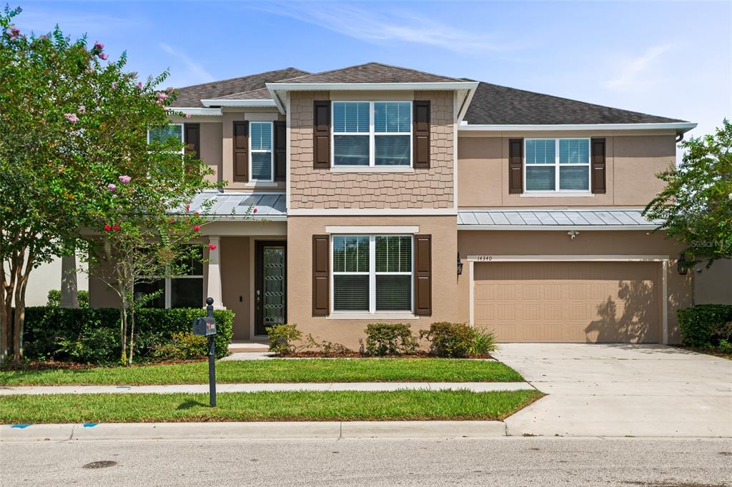 14340 Magnolia Ridge Loop Winter Garden, FL 34787 - Photo 1 of 1 a front view of a house with a garden and yard