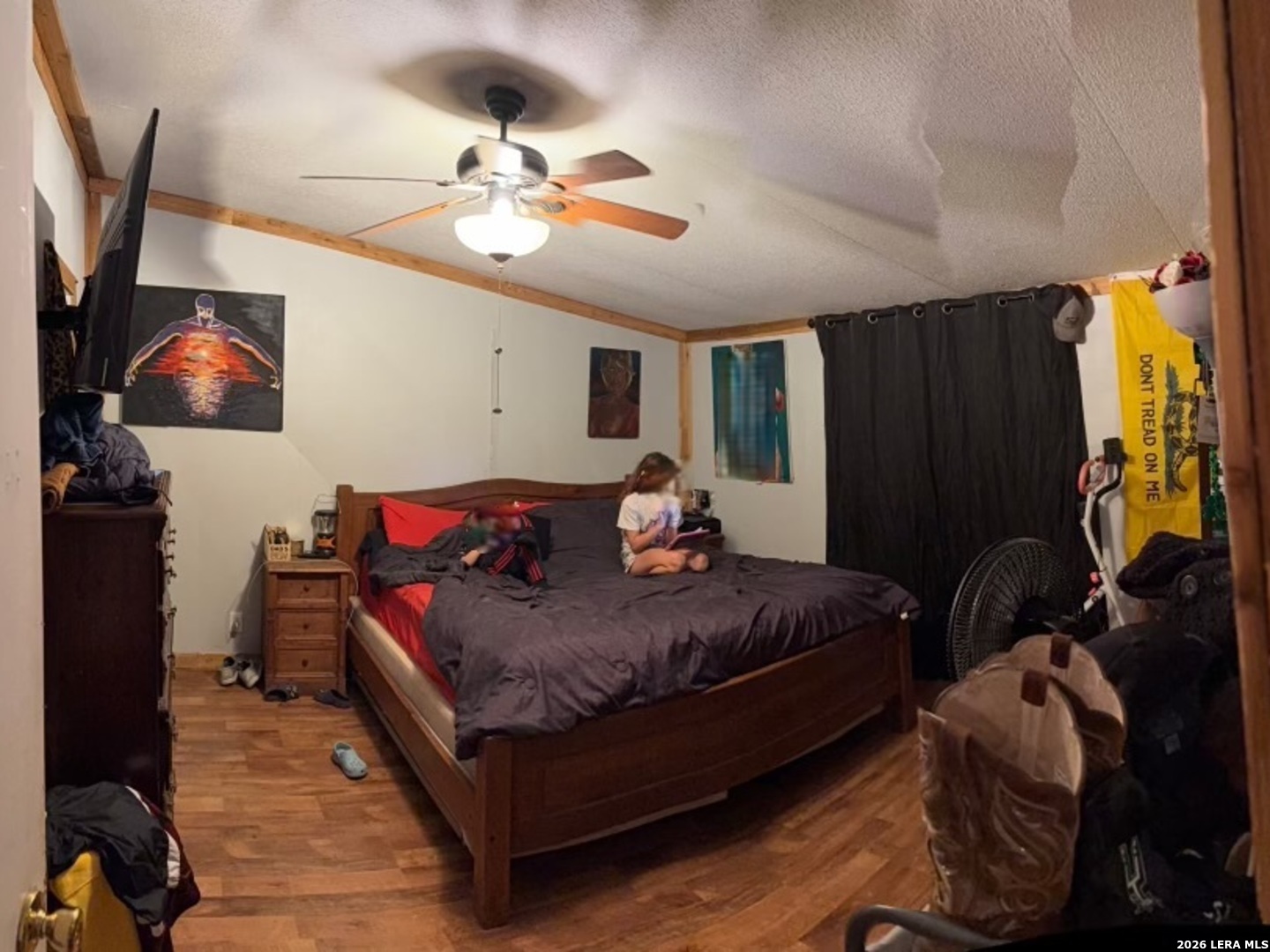 6940 Green Valley Road Schertz, TX 78108 - Photo 8 of 17 a bedroom with bed and a chandelier