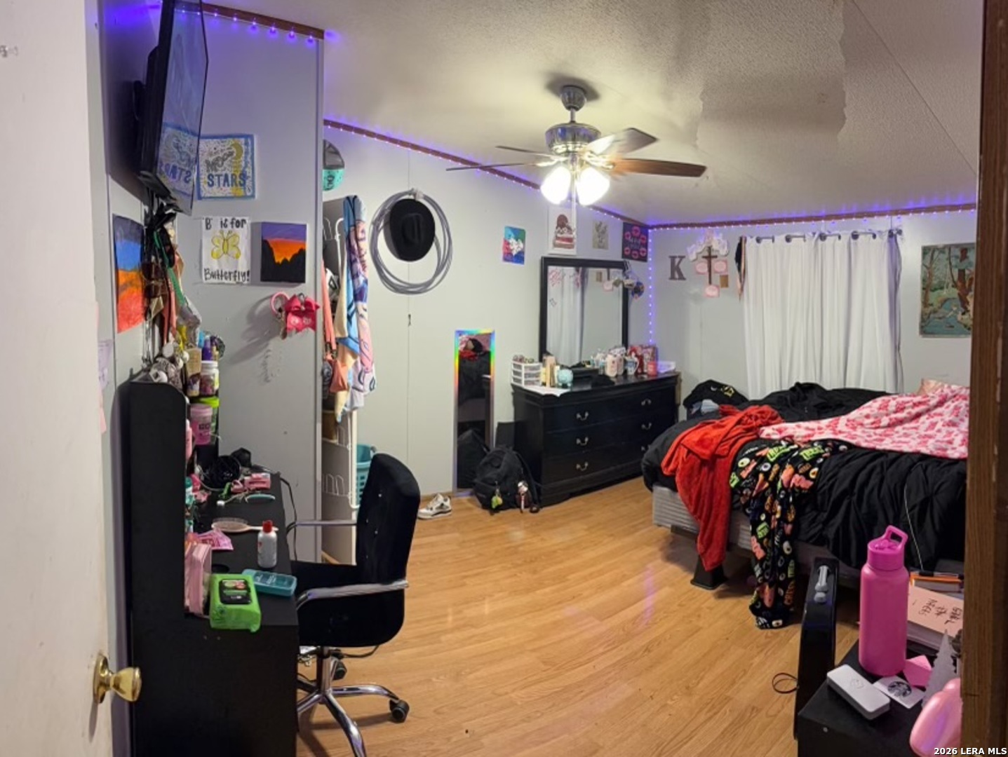 6940 Green Valley Road Schertz, TX 78108 - Photo 10 of 17 a bed room with a bed and a chandelier