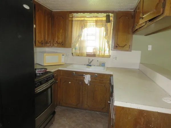 a kitchen with a sink a stove and cabinets