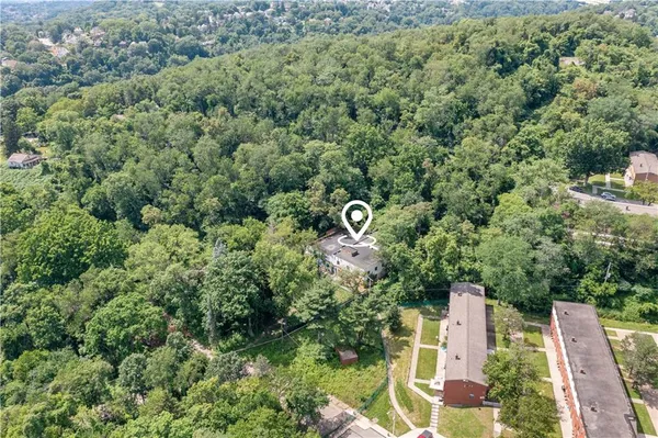 an aerial view of a house with a yard