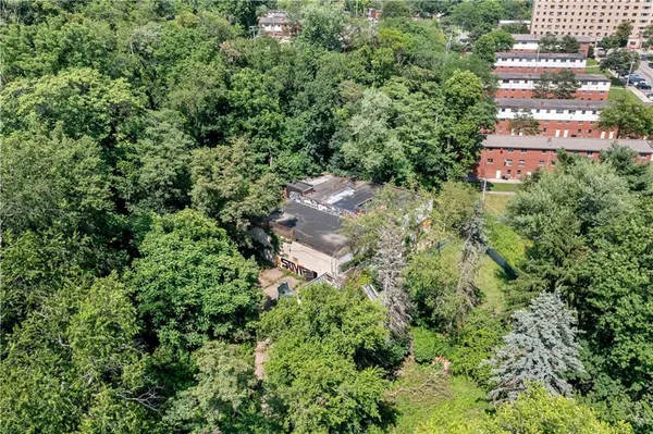 an aerial view of a building with trees