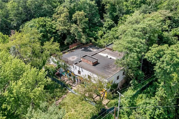an aerial view of a house with a yard