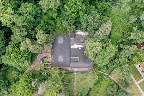an aerial view of a house with a yard