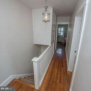 216 Rockingham Road Bryn Mawr, PA 19010 - Photo 16 of 27 a view of a hallway with wooden floor and staircase