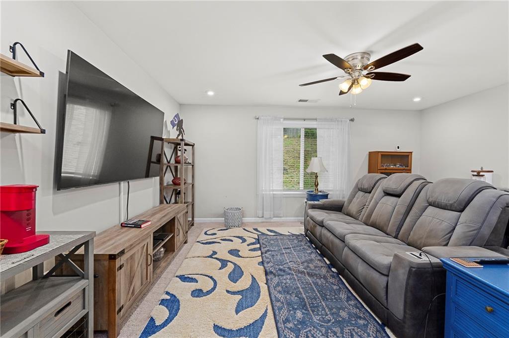 230 Augusta Walk Canton, GA 30114 - Photo 25 of 56 a living room with furniture and a flat screen tv