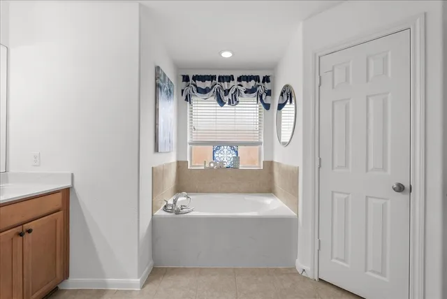 a bathroom with a tub and shower