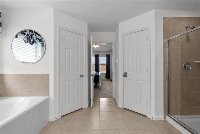 a bathroom with a bathtub and a shower